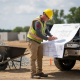 Civil engineer reviewing site grading plans outdoors