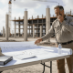 Engineer reviewing electrical plans at construction site
