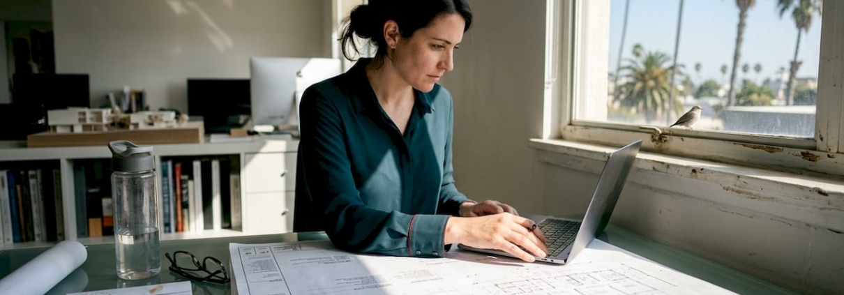 Architect reviewing Florida project blueprints